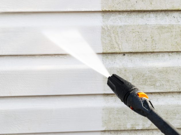 Cleaning service washing building facade with pressure water. Cleaning dirty waill with high pressure water jet. Power washing the wall. Ceaning the facade of the house. Before and after washing